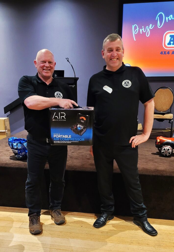 Neville presenting Steven Miller with his raffle prize (ARB Compressor)
